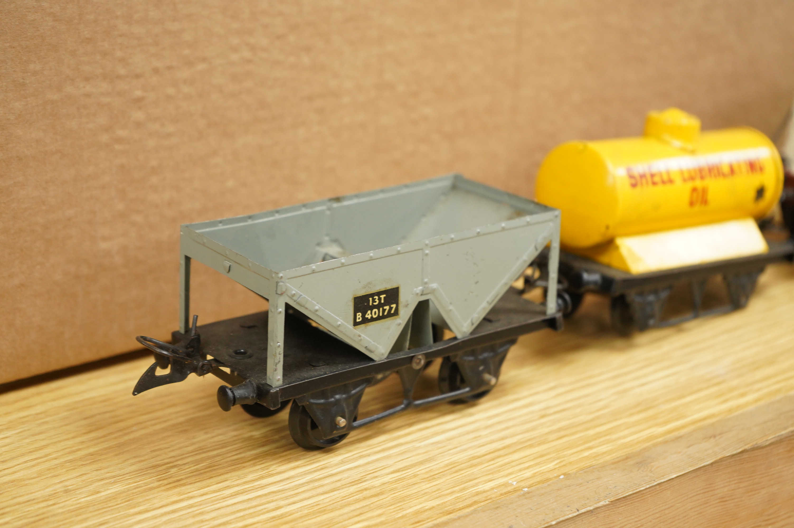 A collection of 0 gauge Hornby tinplate clockwork railway, including four BR locomotives, 17 freight wagons and four wheel coaches, together with a station building, signal cabin, and Goods depot (missing base), plus a f